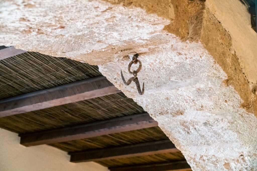 a pair of scissors hanging from the side of a building